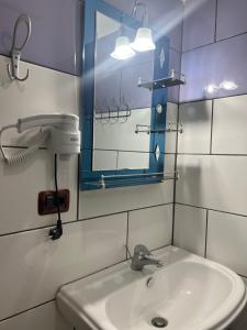 a bathroom with a sink and a mirror at Hotel Asteri in Velipojë