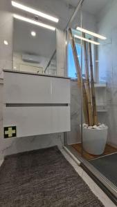 a bathroom with a white dresser and a mirror at Varandas de Luz in Armação de Pêra