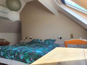 a bedroom with a bed and a table and a window at Le Domaine Augenaies Maison d hôtes et Spa 