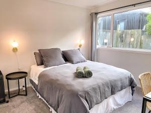a bedroom with a bed with two towels on it at Cozy n Comfortable,5 mins to airport in Wellington