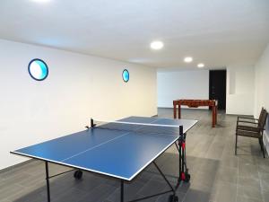 a ping pong table in the middle of a room at Passion by Check-in Portugal in Albufeira