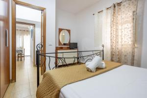 a bedroom with a bed and a desk and a mirror at Casa Vacanze Cappuccini in Palermo
