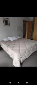 a large white bed in a bedroom with at Valentim House in Viana do Castelo