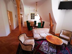 a living room with a couch and a table at Herrnhof in Reichenau