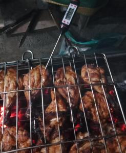 a rack of food cooking on a grill at Arabian Nights Munnar in Munnar