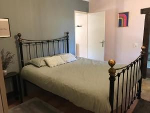 a bedroom with a large bed with a wooden frame at The cosy retreat in Mornay-sur-Allier