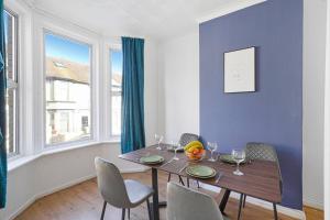 吉林漢姆的住宿－Reve Bleu，一间配备有桌椅和蓝色墙壁的餐厅