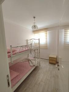 a bedroom with two bunk beds and a window at ÖZLEM APART in Didim