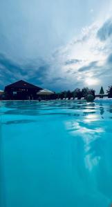 a large pool of blue water in front of a building at SUN GARDEN AND POOL 