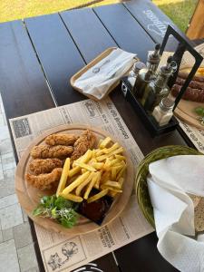 a plate of food with chicken tenders and french fries at SUN GARDEN AND POOL 