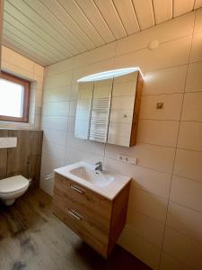 a bathroom with a sink and a toilet at Gästehaus Wallner in Presseggen