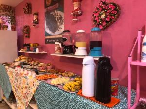 a buffet of food on a table in a room at Pousada Chuá Chuá in Conservatória