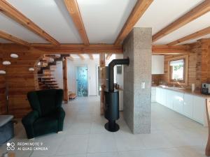 a kitchen with a stove in a room with wooden ceilings at Dom z bala w sercu Podlasia in Białystok
