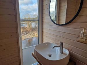 a bathroom with a sink and a mirror at Šušvė in Plinkaigalis +20 photos