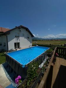 a swimming pool in front of a house at White House Plitvice in Korenica