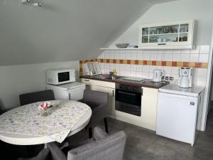 a small kitchen with a table and a table and chairs at Haus Kleinbichler in Faak am See