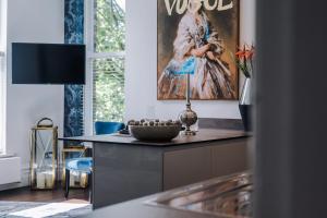 a kitchen with a painting of a woman on the wall at Host & Stay - Princes Park Abode in Liverpool