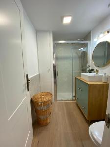 a bathroom with a shower and a sink and a mirror at Isabella Center Boutique in Toledo