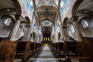 a view of a church with wooden pews at Abdij Hotel Rolduc in Kerkrade