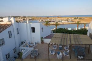 an aerial view of a building with tables and chairs at Boutique Taghostel in Lagos