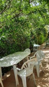 a table and two chairs and a table and a table at Le Temps Des Cerises. in Vinsobres