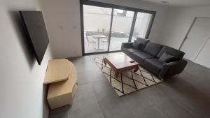 a living room with a couch and a coffee table at Magnifique villa haut standing in Gignac +22 photos