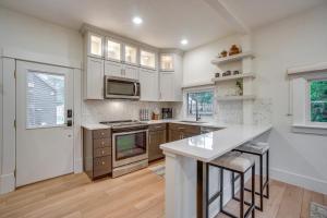 a kitchen with white cabinets and a counter top at Old Town Carriage House with Private Patio in Fort Collins