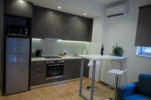 a kitchen with stainless steel appliances and a table at Homey Comfort Apartments in Athens