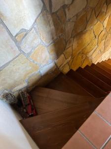 a wooden door in a room with a stone wall at La Maggiorana in Tagliacozzo