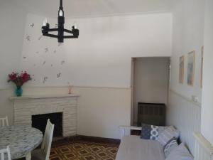 a living room with a table and a fireplace at La Casa de Ischia in Mar del Plata