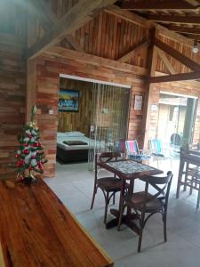a living room with a table and a christmas tree at Casa 600mt da praia, 6km do Beto Carrero in Navegantes