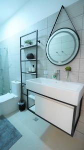 a bathroom with a white sink and a mirror at Villa 213, Residencial Boca Paraíso in Boca Chica