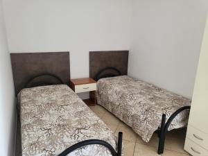 Ein Zimmer mit 2 Betten, einem Nachttisch und einem Bett von 6 x 6 x 6 x 6 x 6 x in der Unterkunft San Silvestro House in Cariati