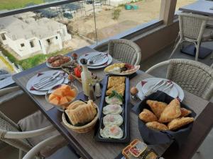 a table with a bunch of food on it at Vista Apartments in Ulcinj