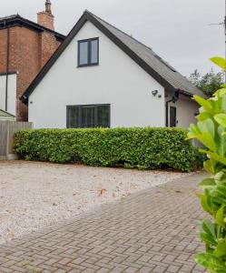a white house with a brick driveway at Executive Boutique Holiday Home - CS in Southport