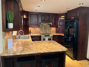 a kitchen with wooden cabinets and a granite counter top at Forks Fir House in Forks