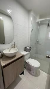 a bathroom with a sink and a toilet and a mirror at Apartamento muy cerca al Mar!-0k in Cartagena de Indias