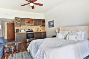 a bedroom with a large bed and a kitchen at Waiakea Villas 4329 condo in Hilo