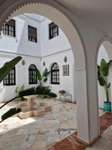 an archway in a building with plants in it at Hotel y Apartamentos Doña Lola in Seville