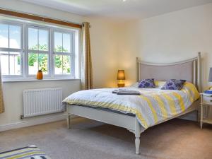 a bedroom with a bed and two windows at Centurion Rise in Penrith