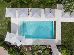 an overhead view of a swimming pool with umbrellas at La Nauve, Hôtel & Jardin - Relais & Châteaux in Cognac