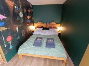 a bedroom with a bed with two pairs of shoes on it at Porta Green in Budapest