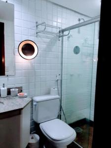 a bathroom with a toilet and a glass shower at Flat LakeSide -Vista para o lago C17 in Brasilia