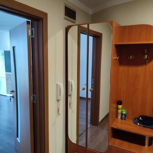 a bathroom with a mirror and a wooden cabinet at Eleny home in Burgas City