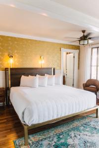 a bedroom with a large white bed in a room at The Gibson Inn in Apalachicola
