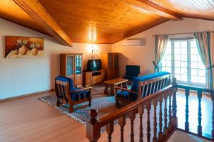 a living room with two chairs and a table at Casa Malheiro in Ponte de Lima