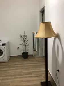a lamp in a living room with a microwave at Ornela Apartments in Durrës