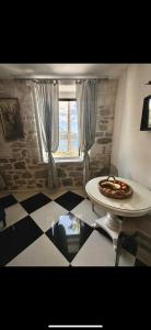 une table avec une plaque de nourriture devant une fenêtre dans l'établissement Apartment Romano, à Korčula