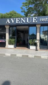 a store with a sign on the front of it at Hotel AVENUE in Ravda