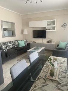 a living room with a couch and a table at Kalliopi Deluxe Apartment in Perea